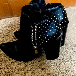 black heeled boots with zipper on side with silver beads on back